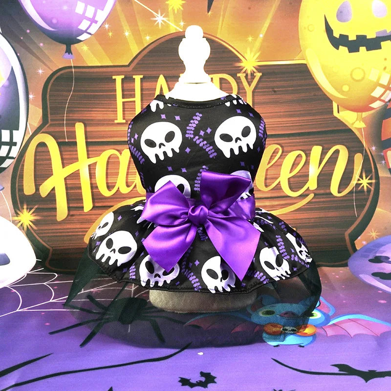 Halloween dog dress for small breeds featuring skull patterns and a purple bow for festive occasions