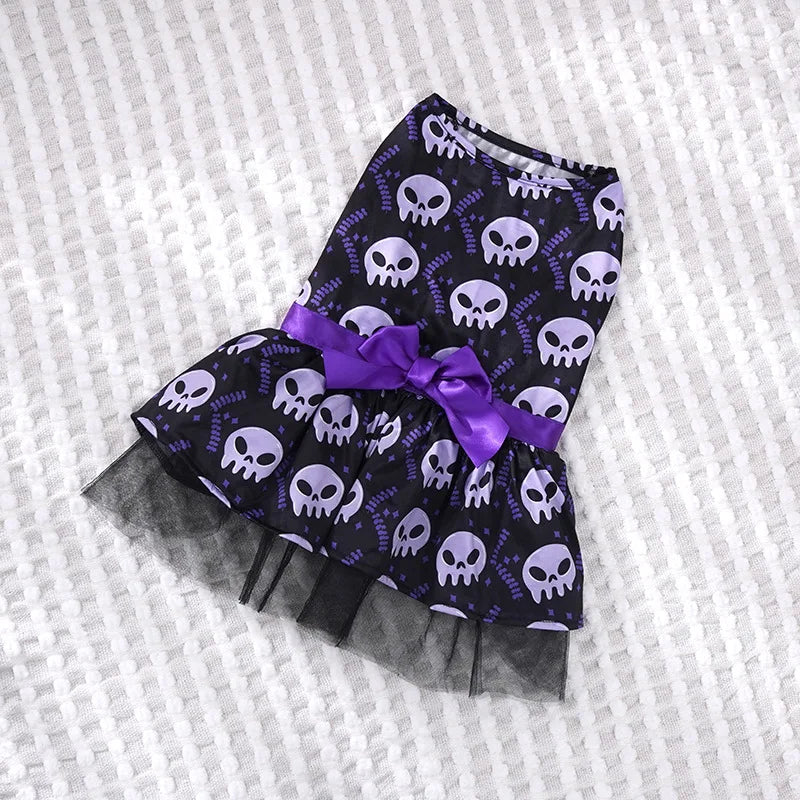 Halloween dog dress for small breeds featuring purple skulls and a purple bow detail