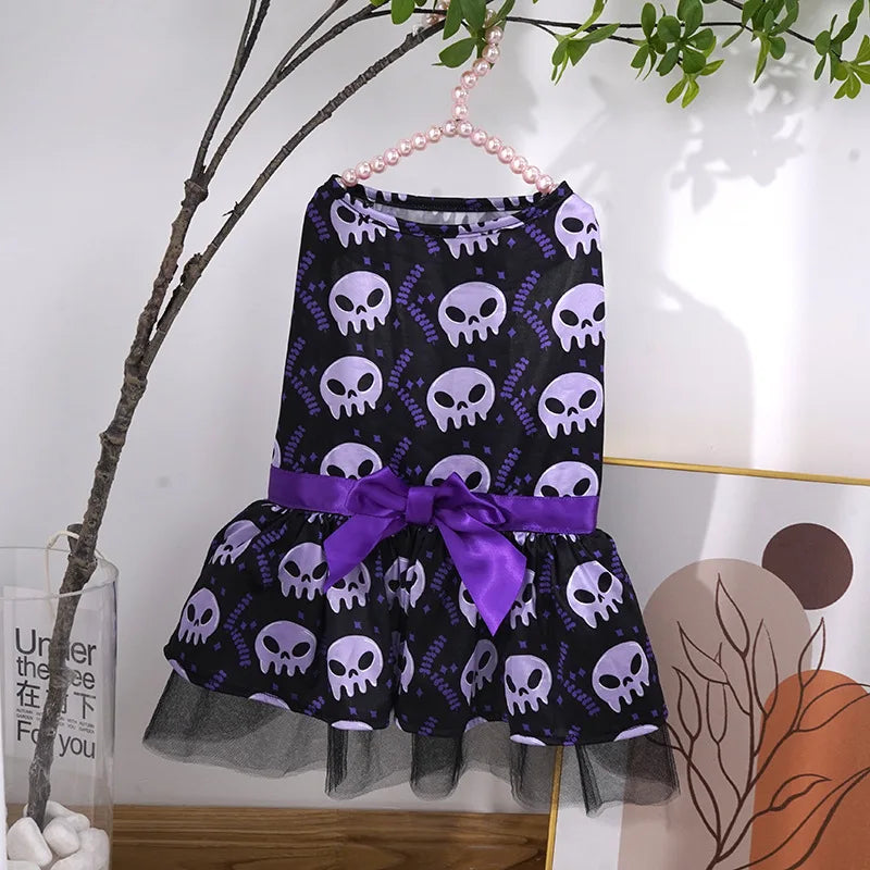 Halloween dog dress for small breeds featuring purple skull design and a purple bow