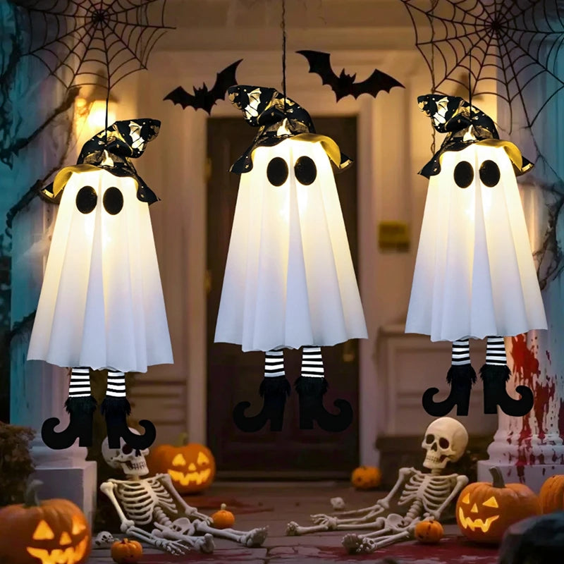 Halloween LED witch ghost decorations hanging outside with pumpkins and skeletons