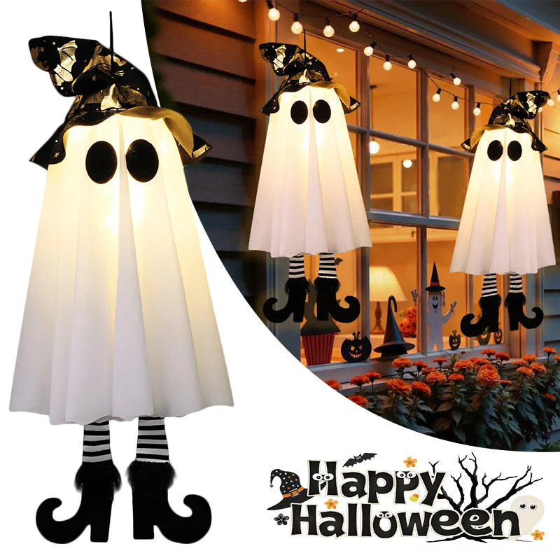 Halloween LED witch ghost decorations hanging by a window with festive lights and a Halloween theme
