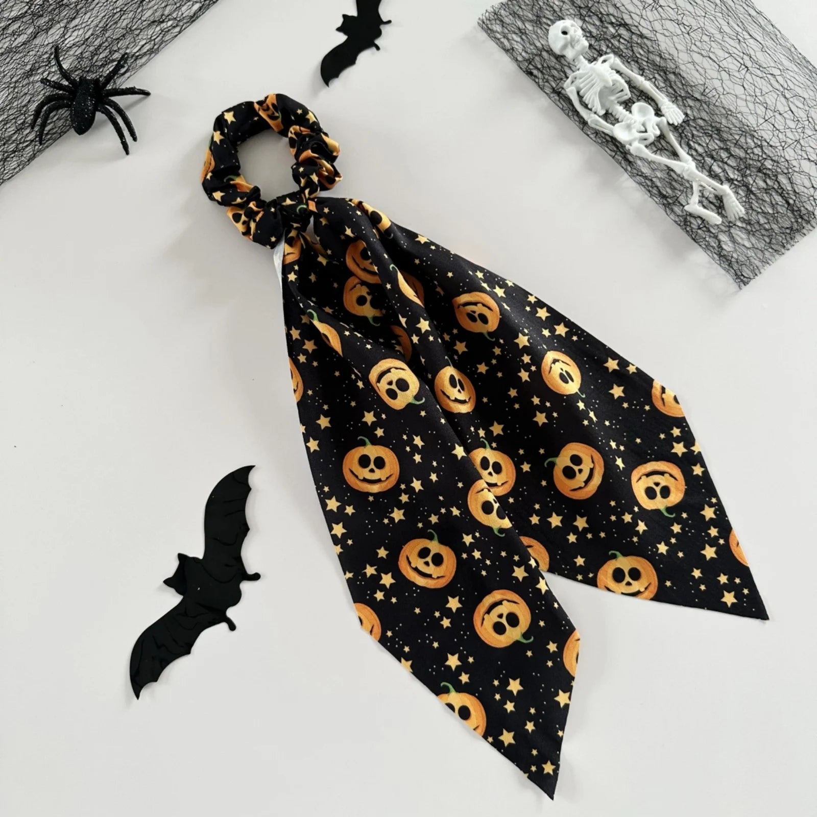 Halloween scrunchies set featuring pumpkin designs and star accents for festive hairstyles