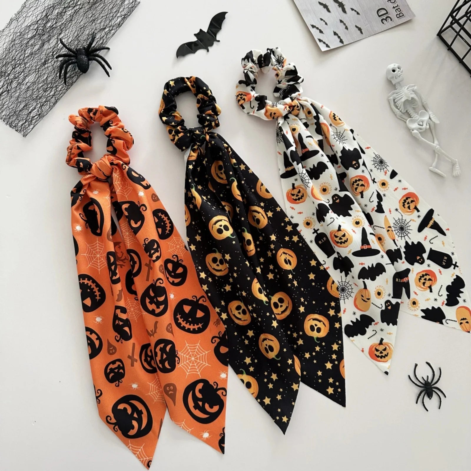 Halloween scrunchies set featuring playful designs of pumpkins, bats, and ghosts for festive hairstyles