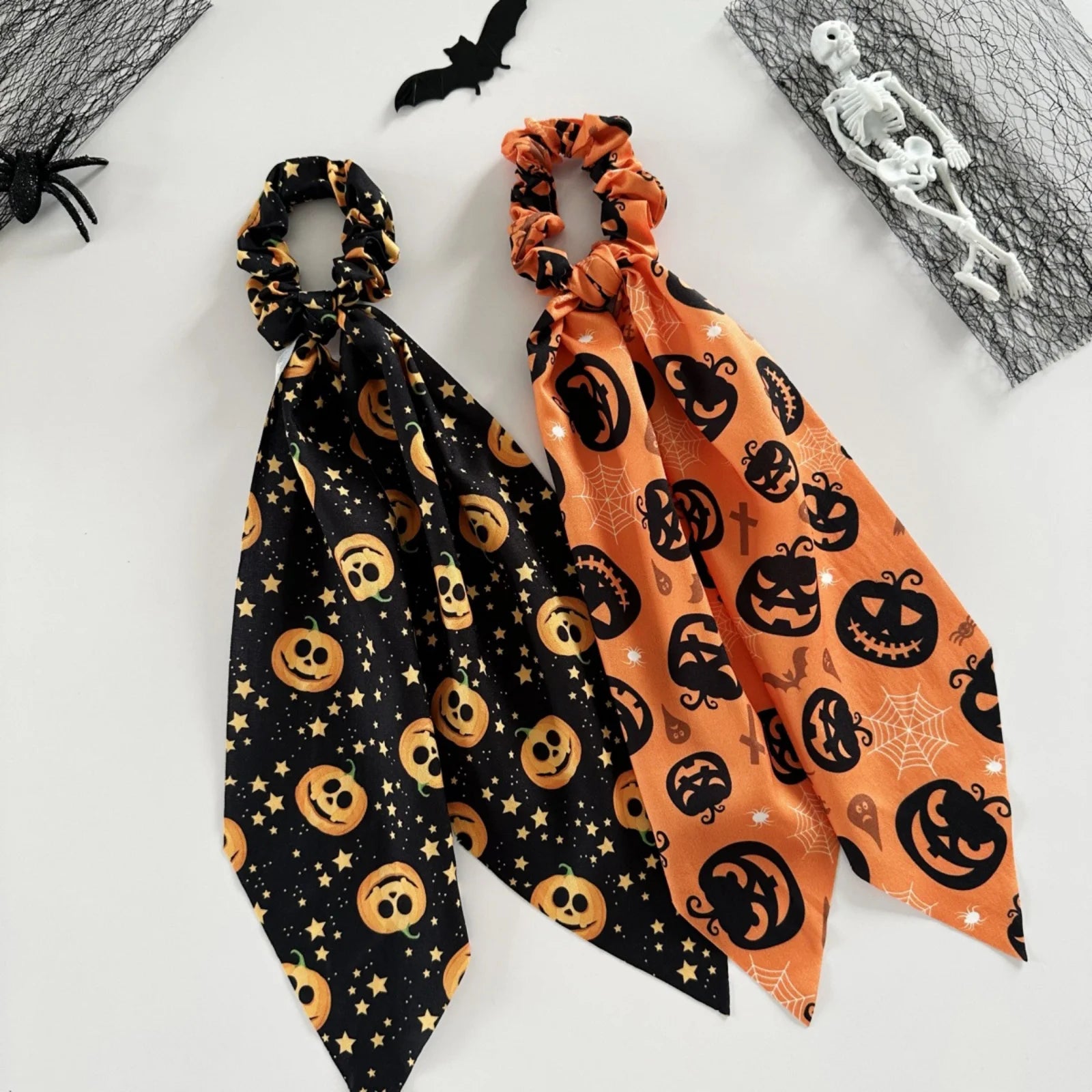 Halloween scrunchies set in black and orange featuring spooky patterns and festive designs