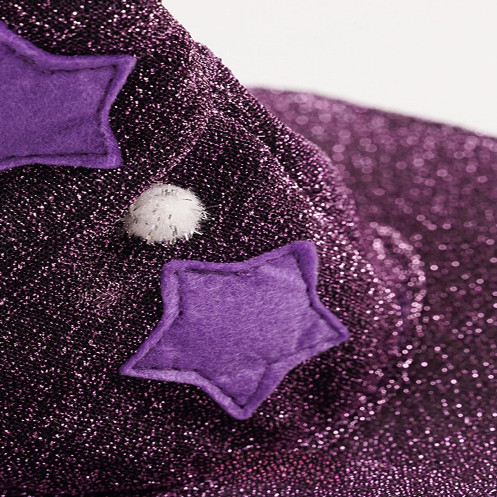 Purple Halloween witch costume for pets featuring stars and sparkly design for festive occasions