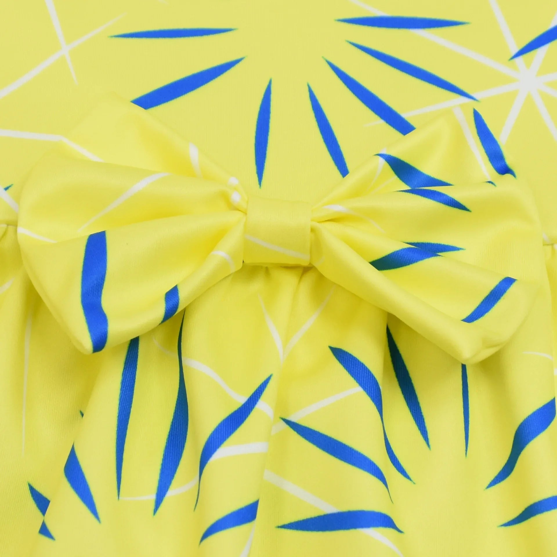 Inside Out Joy Halloween costume featuring bright yellow fabric with blue accents and a bow detail