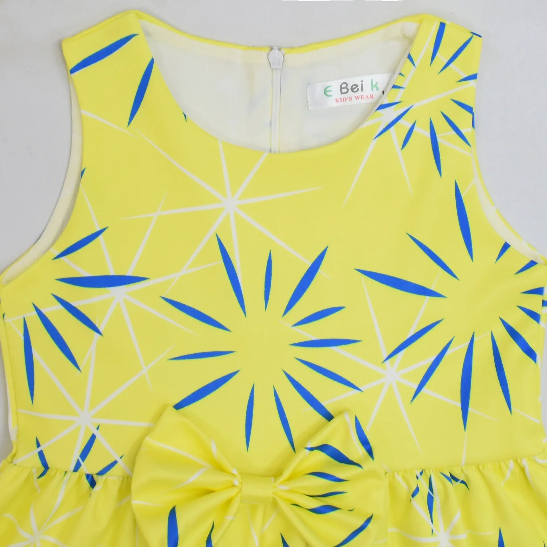 Inside Out Joy Halloween costume dress in bright yellow with blue starburst pattern and bow detail