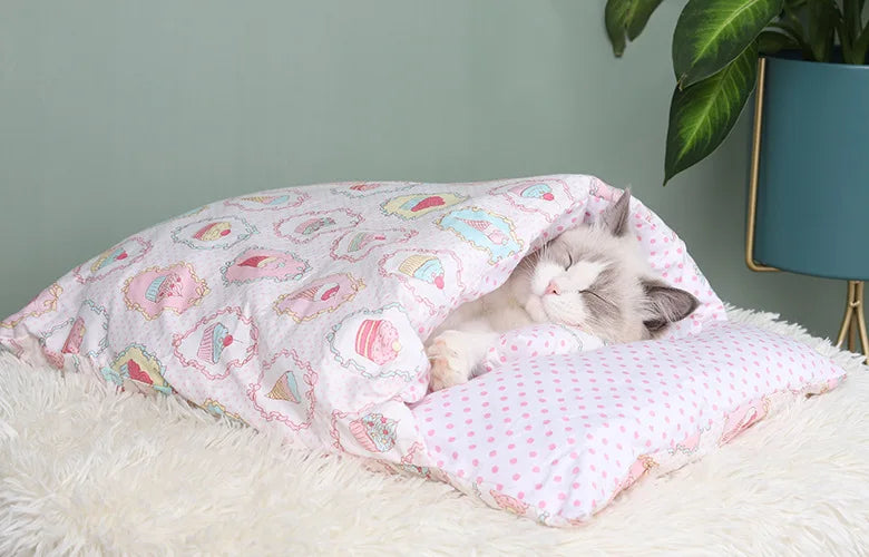 Cozy Japanese cat sleeping bag featuring cupcake patterns with a content cat resting inside
