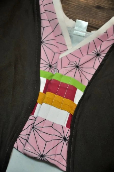 Close-up of a Japanese dog kimono costume featuring colorful patterned fabric and intricate design