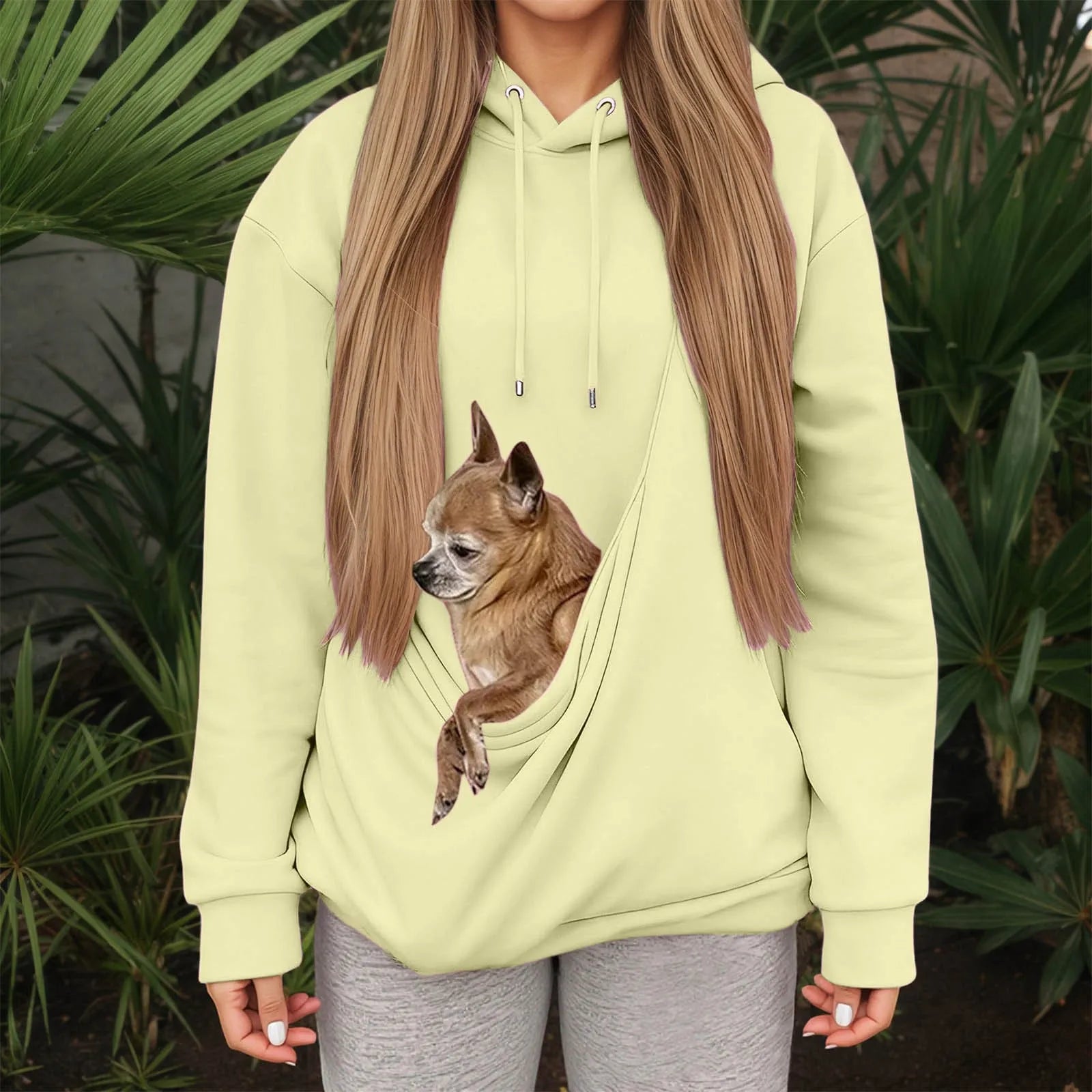 Light green kangaroo pocket pet hoodie for women with a dog nestled inside the pocket