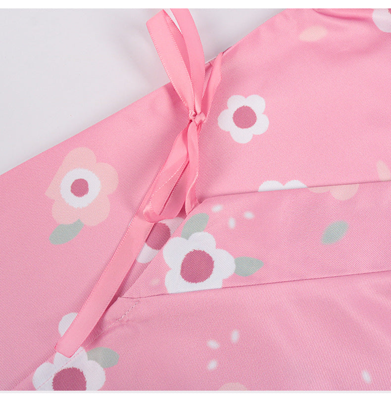 Close-up of the Kanroji Mitsuri cosplay costume pink fabric with floral patterns and ribbon details
