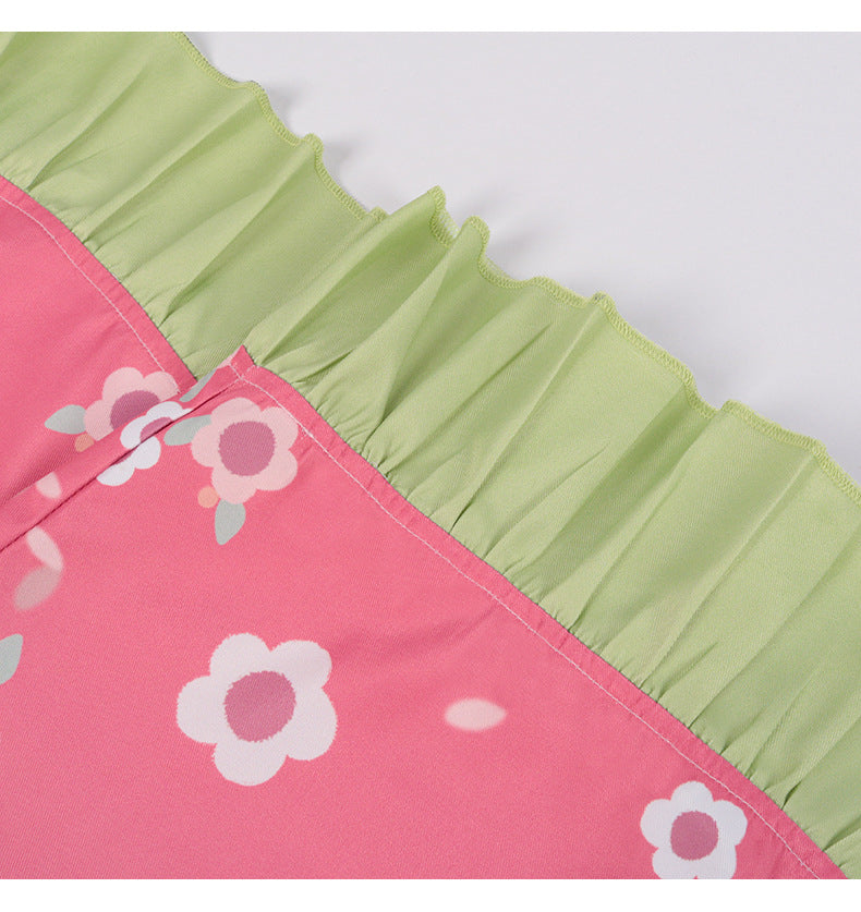 Close-up of Kanroji Mitsuri cosplay costume detailing with pink fabric and green ruffled trim