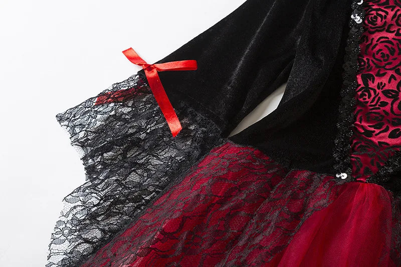 Kids vampire Halloween costume featuring black and red dress with lace sleeves and red ribbon detail
