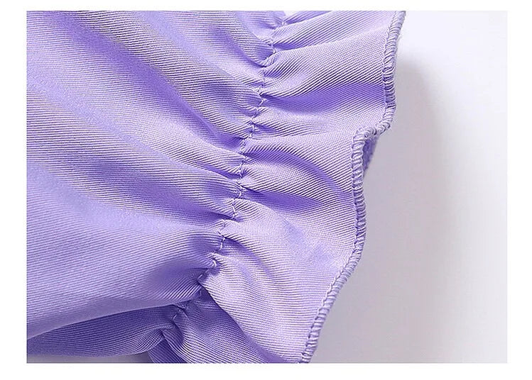 Detail of the lavender Kuromi princess dress for kids featuring ruffled edges and soft fabric