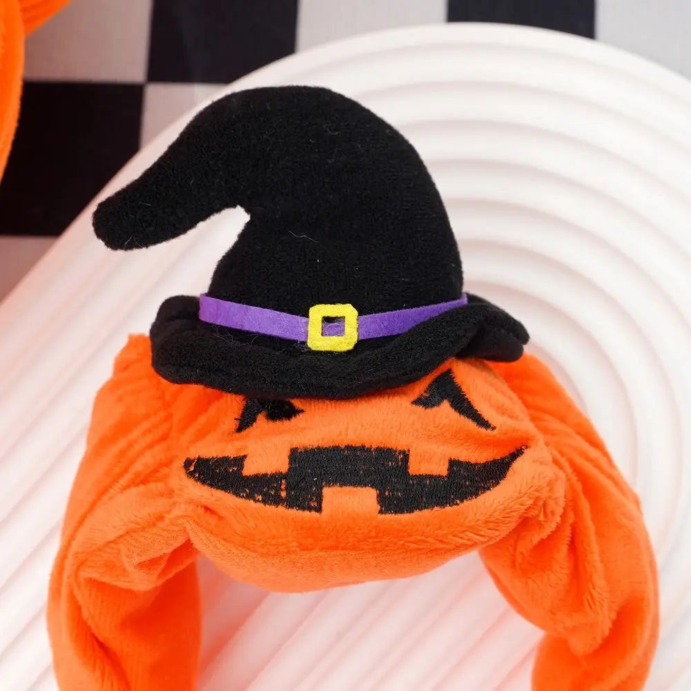 Adorable dog pumpkin costume Halloween with a black witch hat for festive pet celebrations