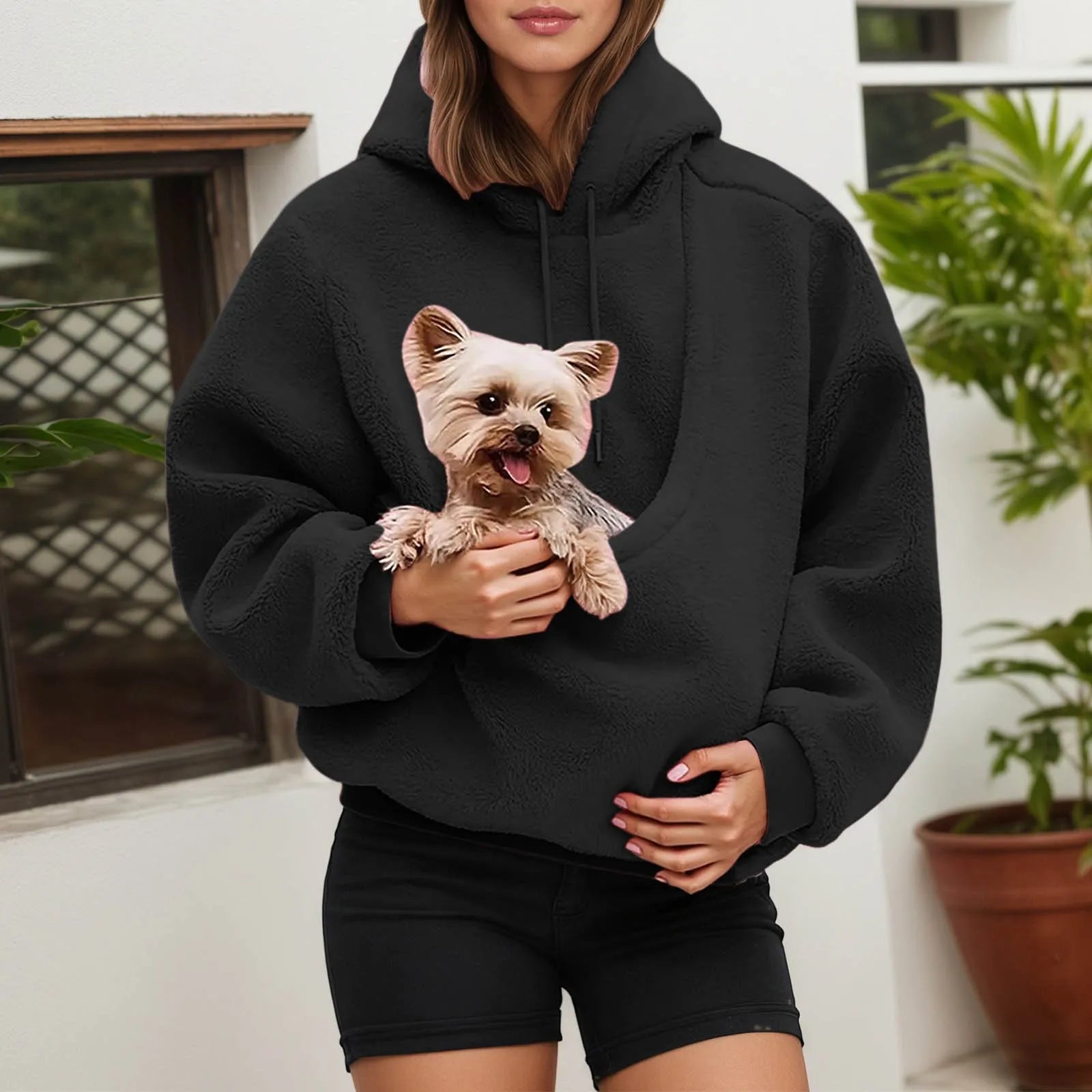 Black pet carrier hoodie featuring a cozy pocket for small pets like dogs or cats