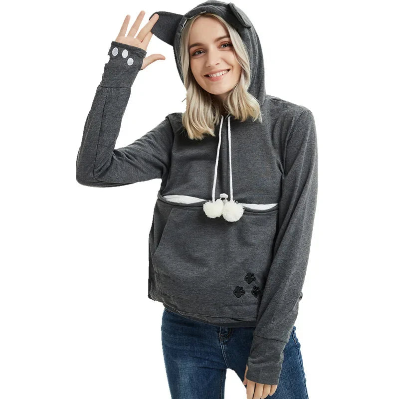 Cozy pet carrier kangaroo sweatshirt with a hood and playful paw print design for pet lovers