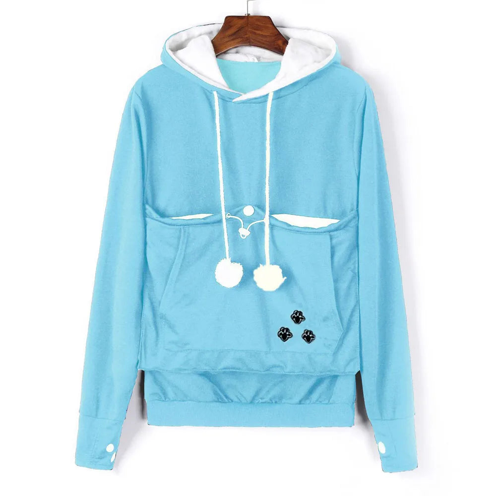 Light blue pet carrier kangaroo sweatshirt with front pockets and pom poms for added style and comfort