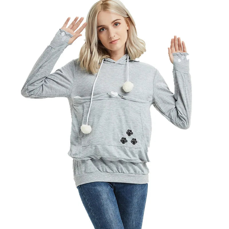 Cozy pet carrier kangaroo sweatshirt in gray with paw print design and pom-pom accents