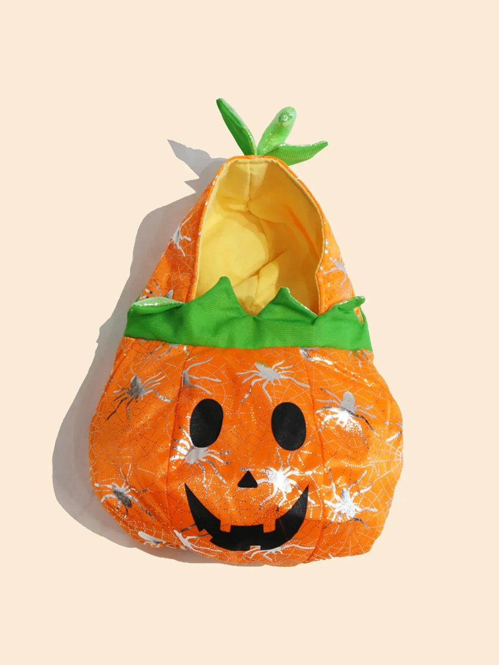 Adorable pet pumpkin Halloween costume with a smiling face and green leaf accents for festive fun