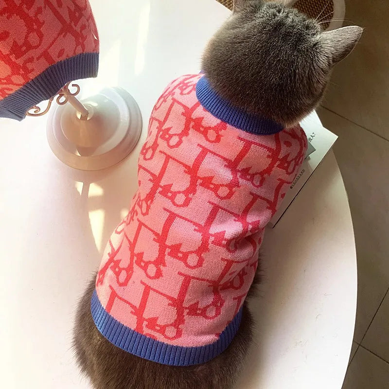 Cozy pink dog sweater for small dogs featuring a playful design and comfortable fit