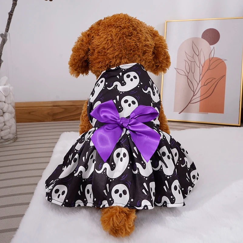 Cute dog in a black and white ghost patterned dress featuring a purple bow, perfect for Halloween, pumpkin pet skirt for dogs