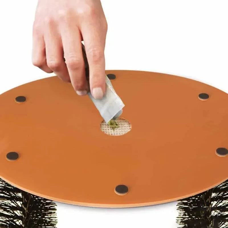 PurrSpa Self-Grooming Cat Arch with a hand placing catnip for added attraction and playtime fun