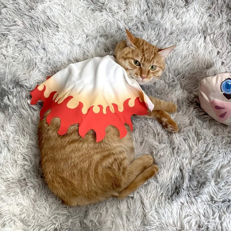 Orange Cat Wearing Rengoku Pet Cosplay Costume with Flame Design on a Soft Blanket