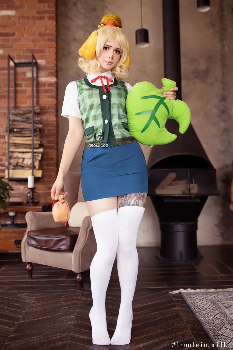 Cosplay of Animal Crossing New Horizons outfit featuring a character holding a green leaf and a peach bag
