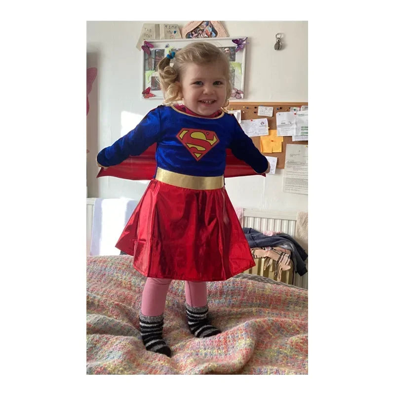 Cute girl wearing a Supergirl Halloween Costume with a blue top and red skirt