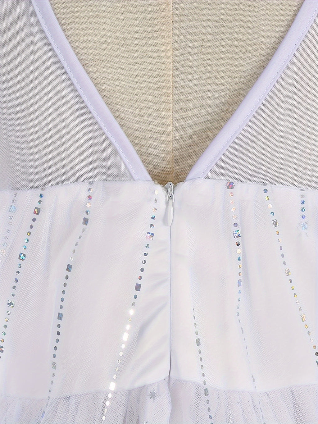 Back view of a white princess dress for girls featuring a zipper and sparkling accents