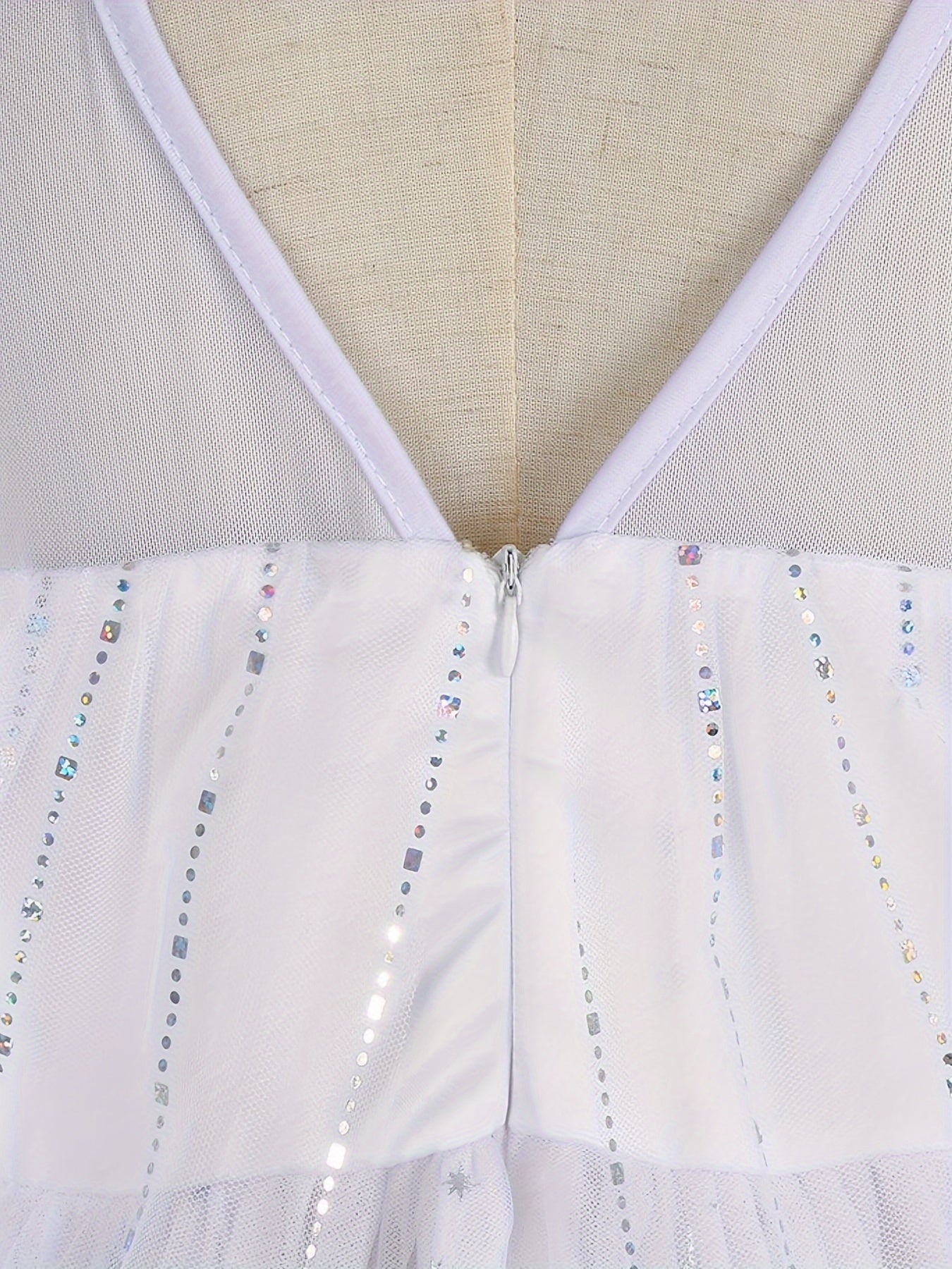 Back view of a white princess dress for girls featuring a zipper and sparkling accents