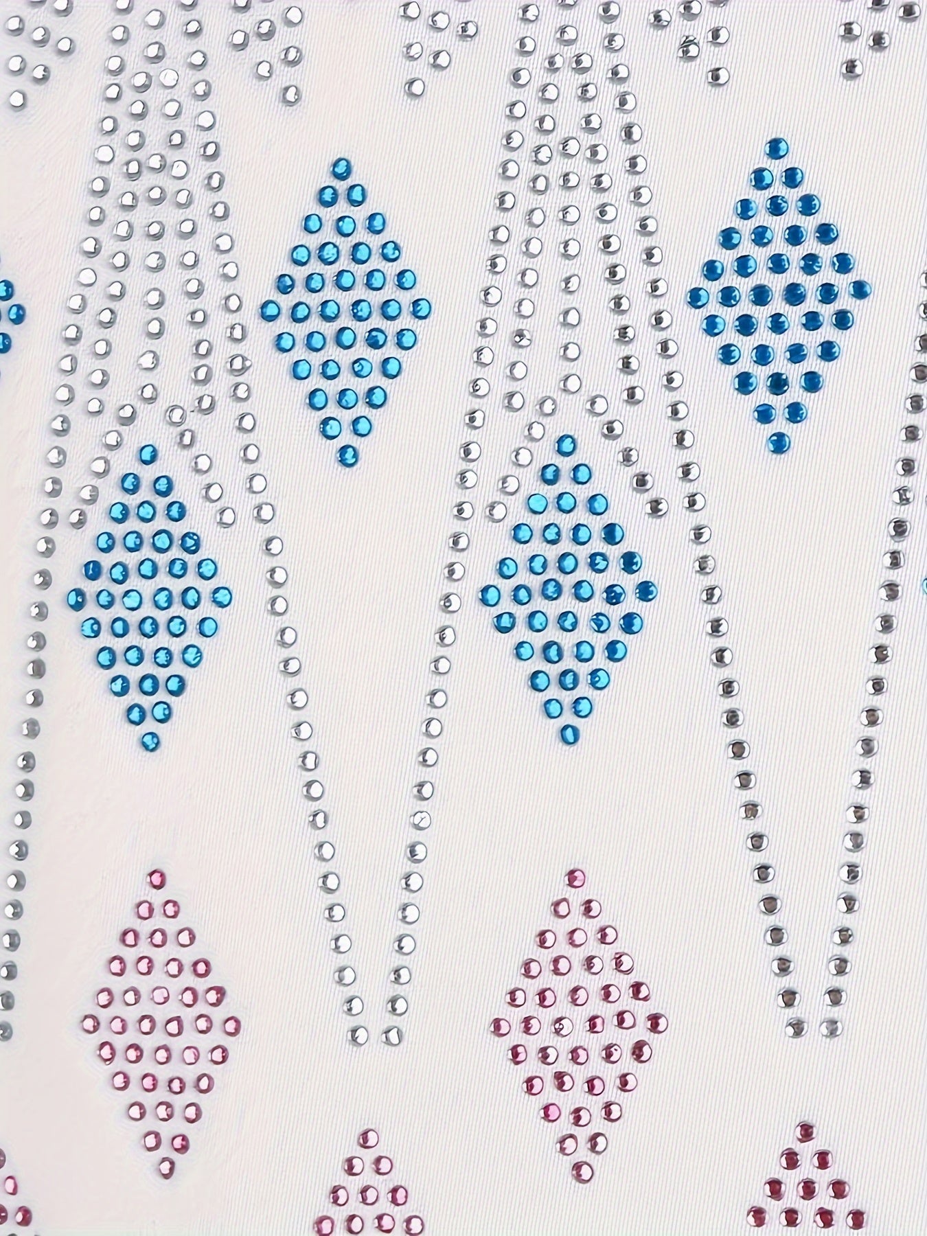 Close-up of the sparkling design on a white princess dress for girls featuring colorful rhinestones