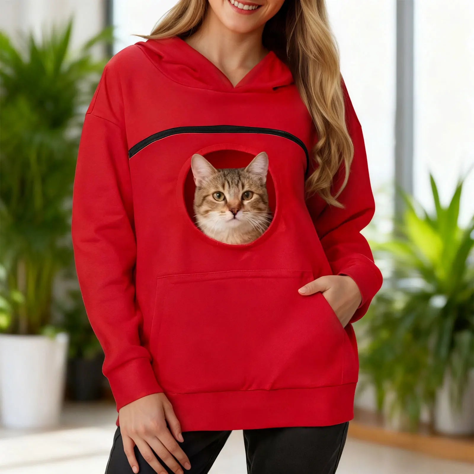 Women's kangaroo pet hoodie in red featuring a front pocket for pets with a cat peeking out